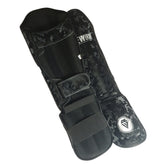 Night Camo Rewon shin guards for kickboxing and MMA in black camouflage design, featuring secure Velcro straps and comfortable fit.